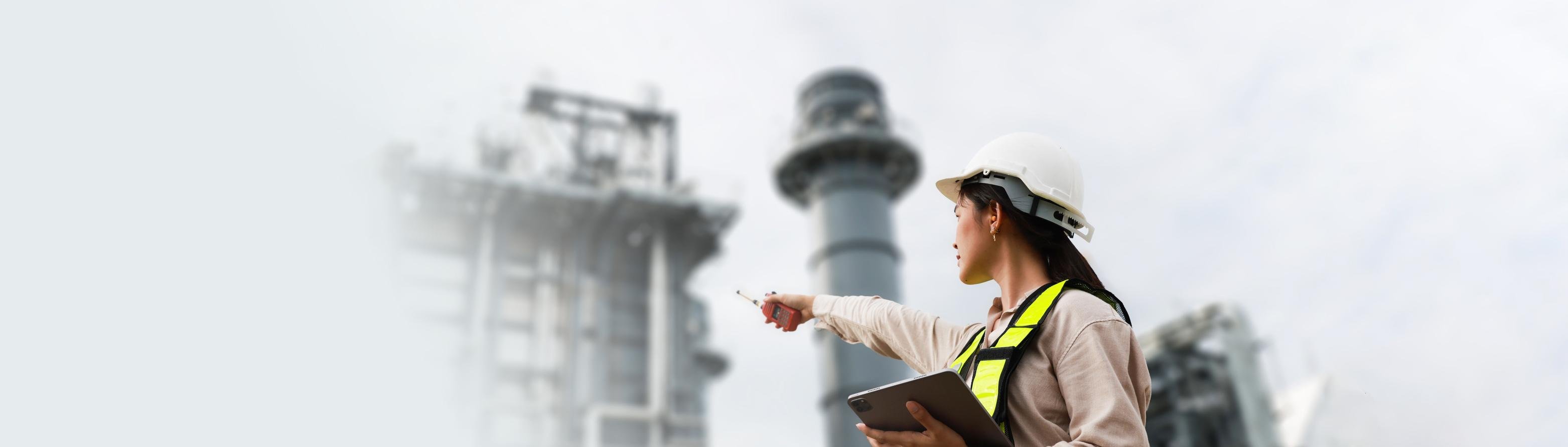 woman pointing to power plant