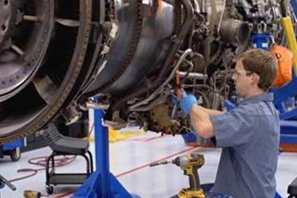 Man servicing a Mitsubishi Power aero-derivative gas turbine